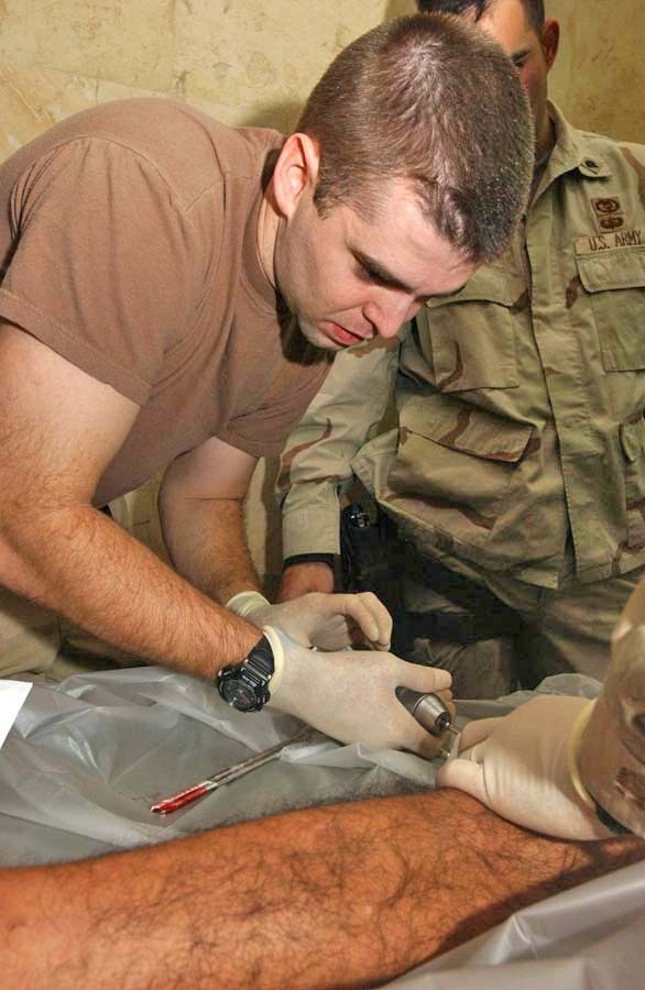 1st Lt. Brian Savage extracts steel screws