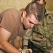 1st Lt. Brian Savage extracts steel screws