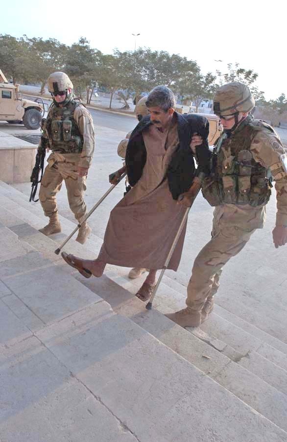 Paratroopers help Kadaam Hassoun into their aid station