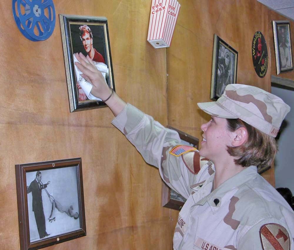 Spc. Raechel Avallone dusts off a picture of Patrick Swayze