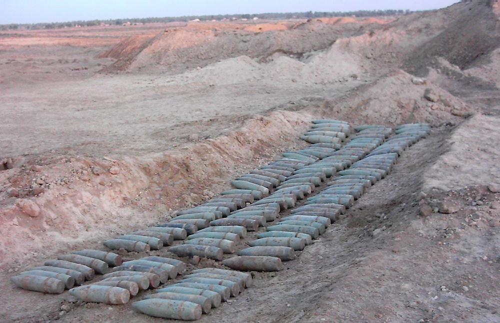 Hundreds of artillery rounds are laid out on the ground