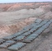 Hundreds of artillery rounds are laid out on the ground