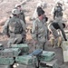 Soldiers stand amidst thousands of small arms ammunition