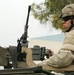 Spc. Jessy Nix scans a Baghdad street while pulling security