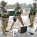Soldiers search through the belongings of a suspect