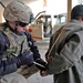 Spc. Mark Gunthrope places flexi-cuffs onto a suspect