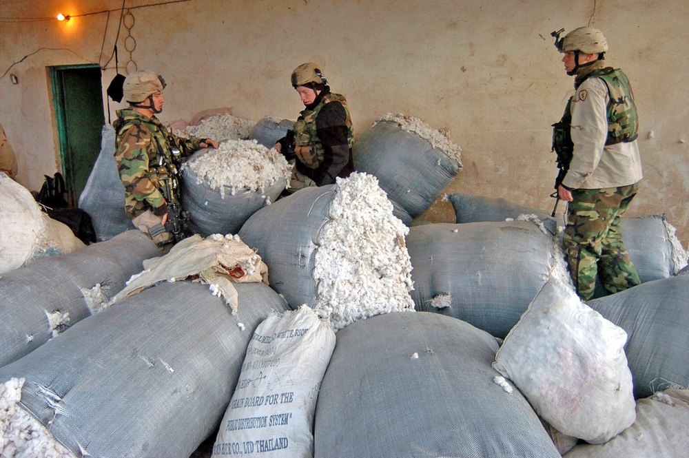 Soldiers search through bags of sheep fur