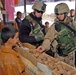 Soldiers purchase items at an Arab market