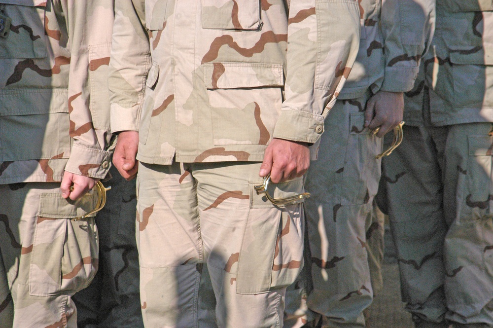 Soldiers stand in formation prior to ceremony