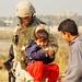 Sgt. Mark Jones playfully chastises a young Iraqi child