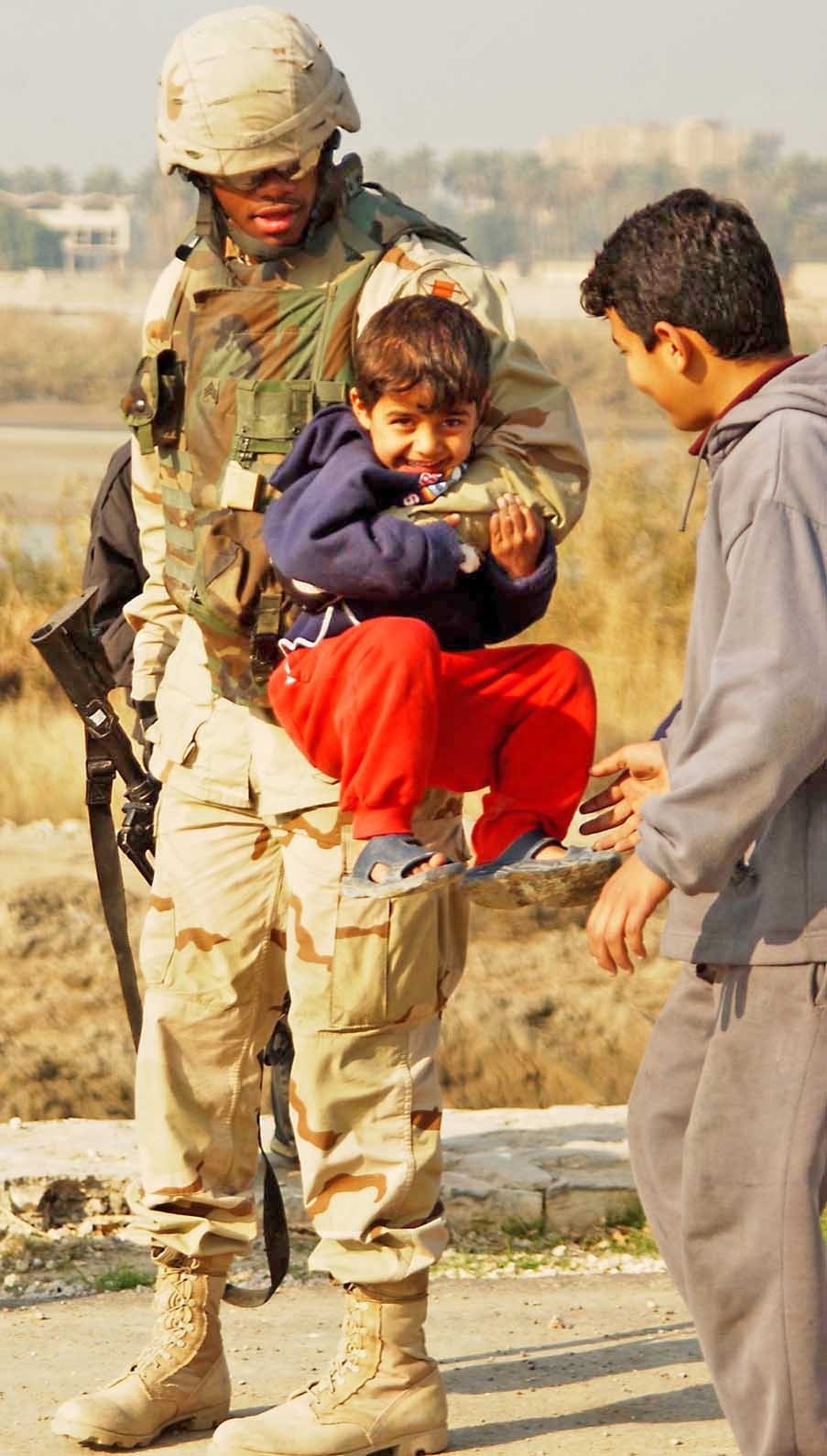Sgt. Mark Jones playfully chastises a young Iraqi child