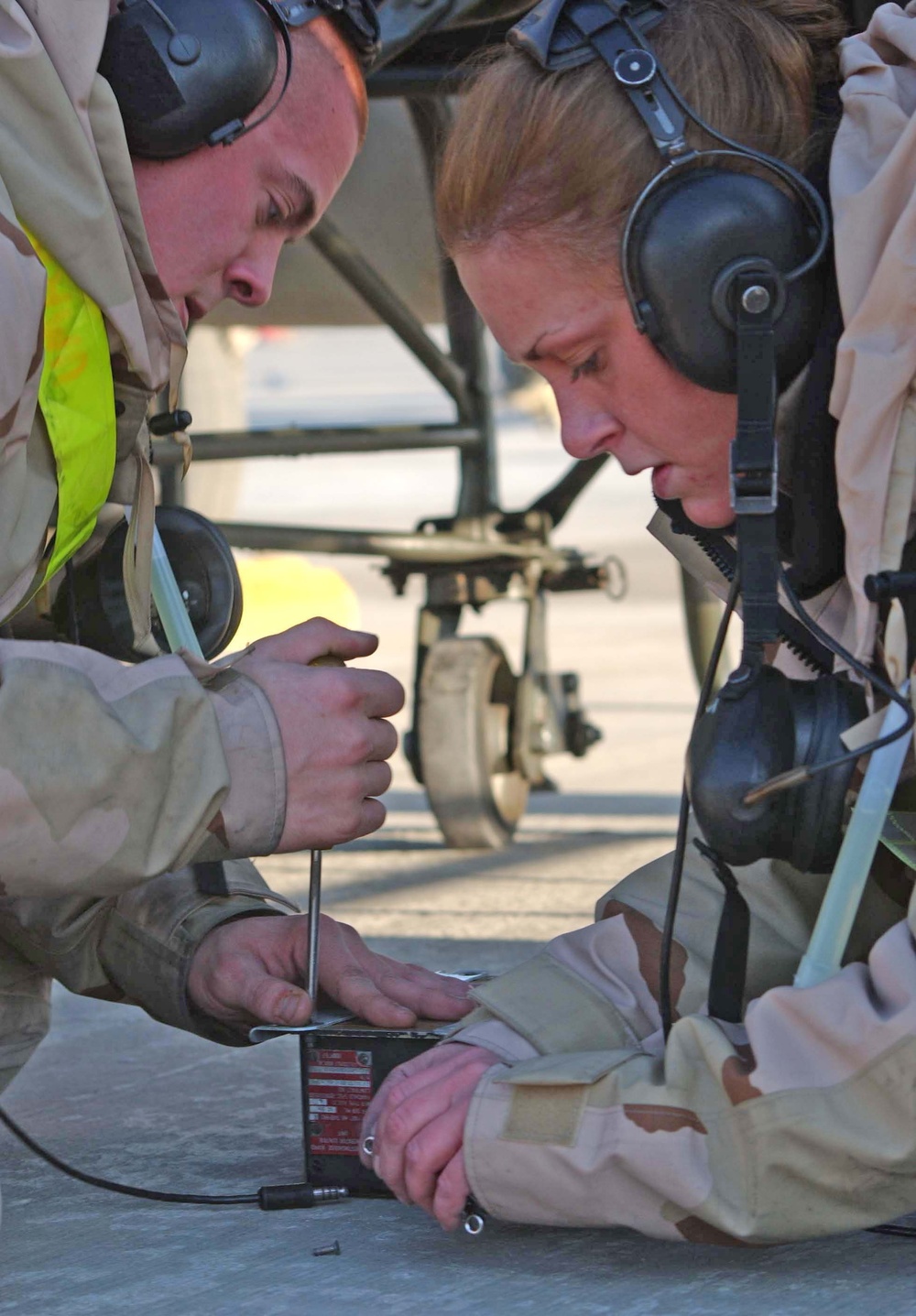 Air Force Airmen work to replace a generator control unit