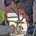 Air Force Airmen work to replace a generator control unit