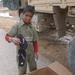 An Iraqi boy picks out a pair of flip flops