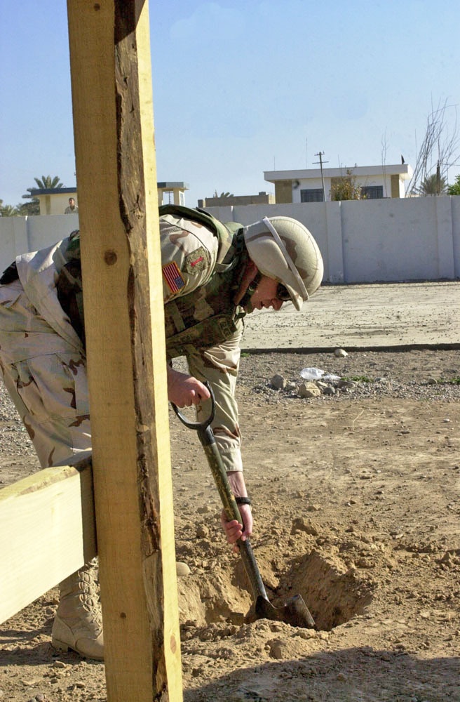 Cpt Bret Gilmore digs a hole to place a play system