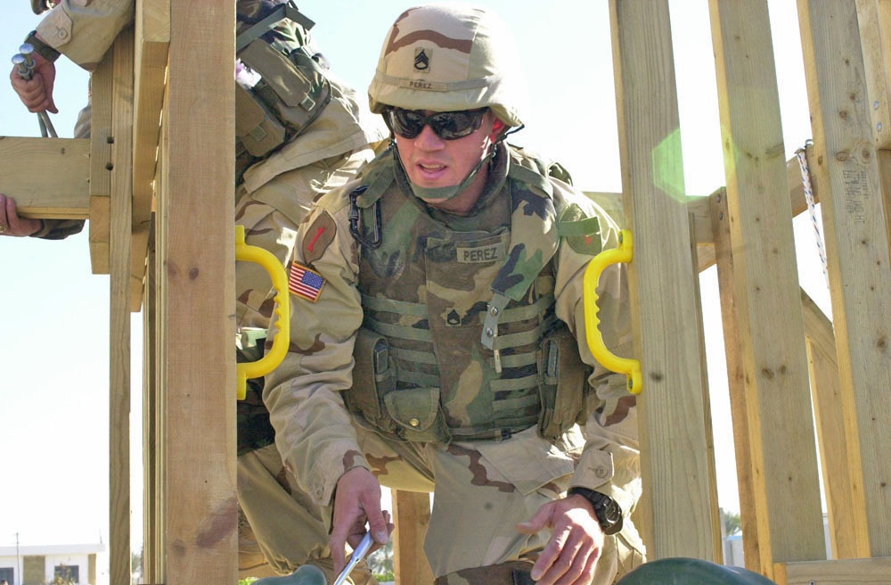 SSgt Perez works on the construction of playground system