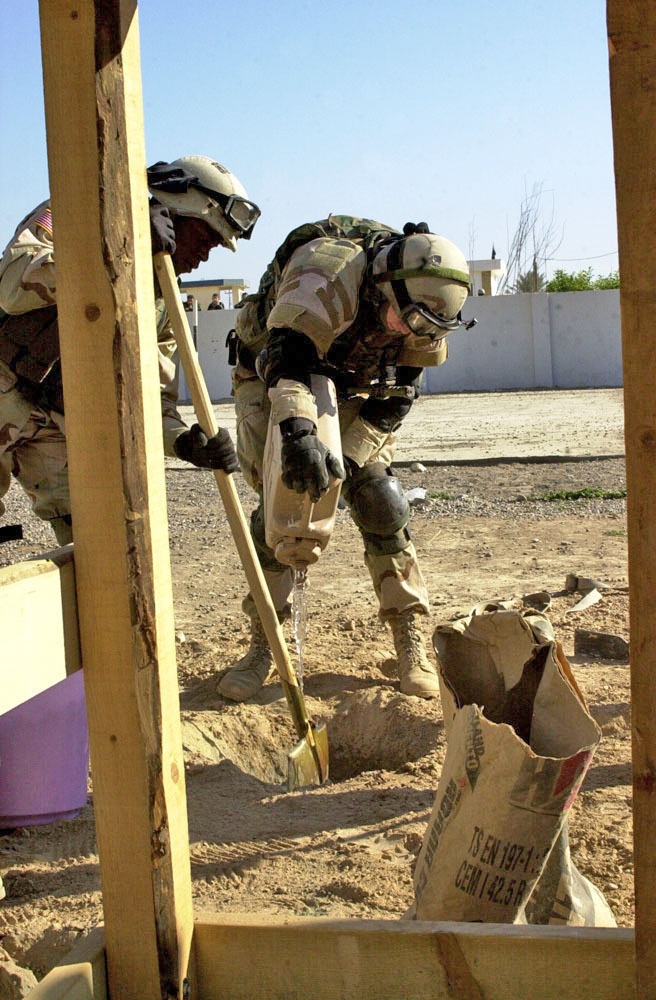 Soldiers mix the concrete for the Playground