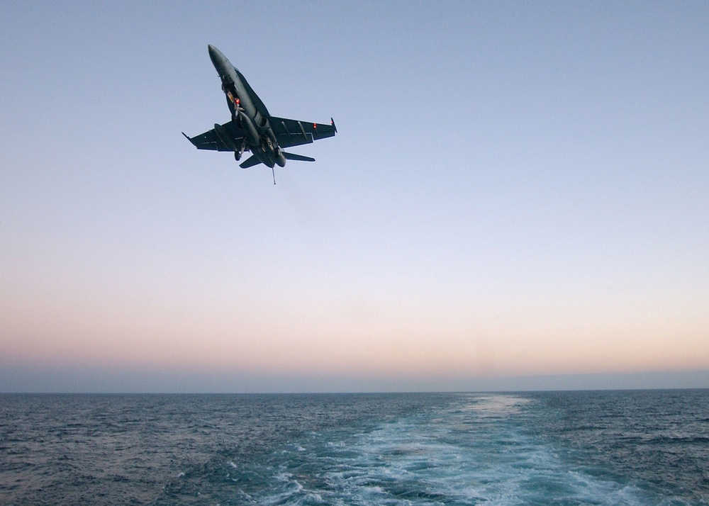 An F/A-18C Hornet approaches the landing area