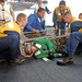 Stretcher bearers prepare to carefully load a simulated casualty