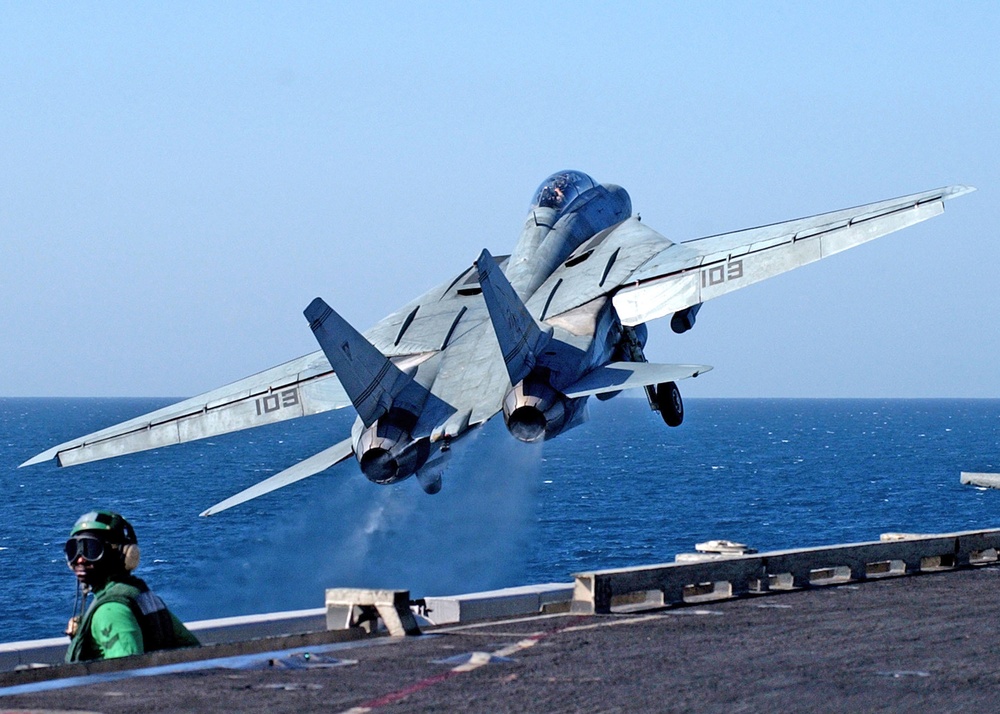 Off the waist catapults, launches an F-14B Tomcat