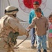 Sgt. Currie shares his food with some Iraqi local children