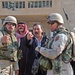 Two Iraqi policeman give a report to Capt. Byard