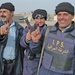 Iraqi Police officers proudly display their ink-covered finger