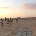 Soldiers take a look at a cache of artillery rounds found