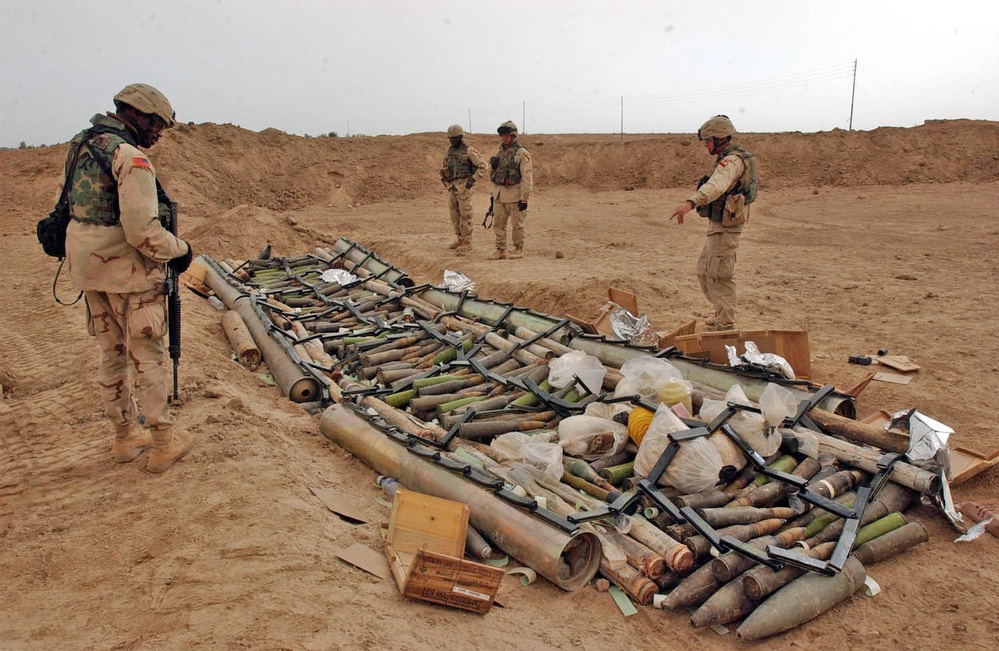 Soldiers take a look at some of the munitions found