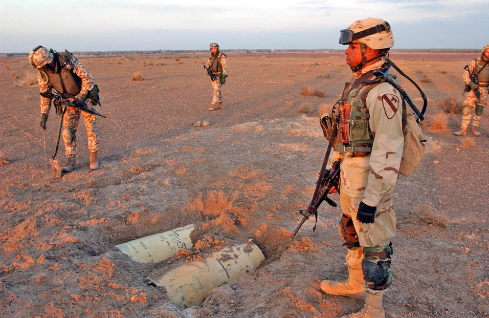 Sgt. Samuel Jones stands by an unearthed cache warheads