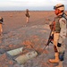 Sgt. Samuel Jones stands by an unearthed cache warheads