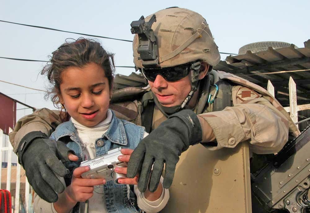 Spc. Thomas Dulinsky and girl Sit on Top of His Humvee