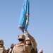 Brig. Gen. Steve Mundt takes the colors from the bearor