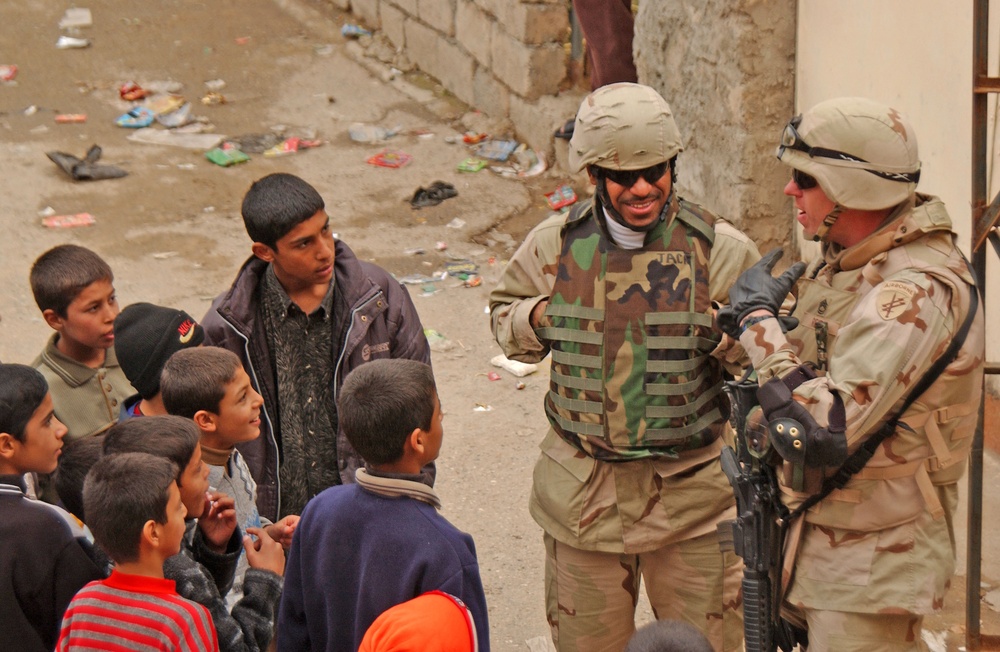 Sgt. 1st Class Reid speaks with a group of residents