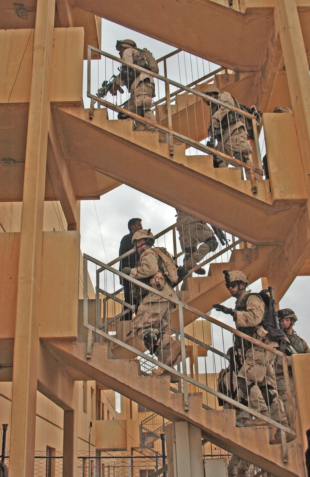 Soldiers move up the stairs to the 2nd and 3rd floor