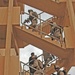 Soldiers move up the stairs to the 2nd and 3rd floor