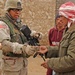 Capt. Byard gives money to a local Iraqi man