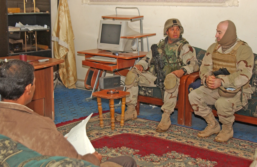 Capt. Byard listens as his translator gives a rundown