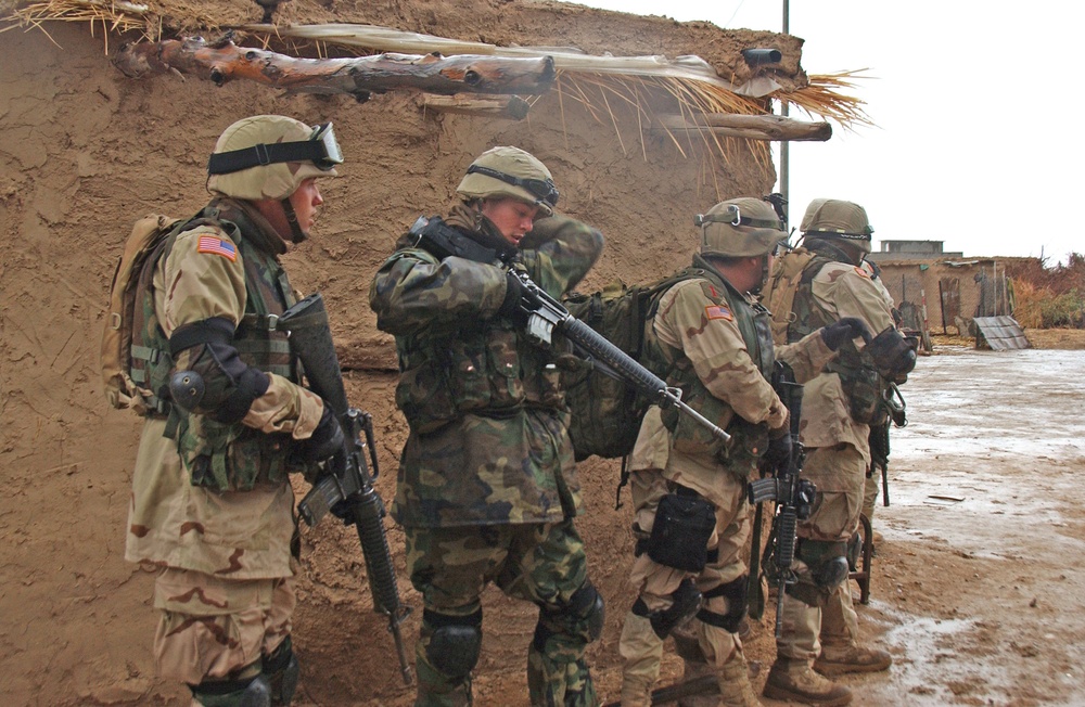 Soldiers prepare to move into the home