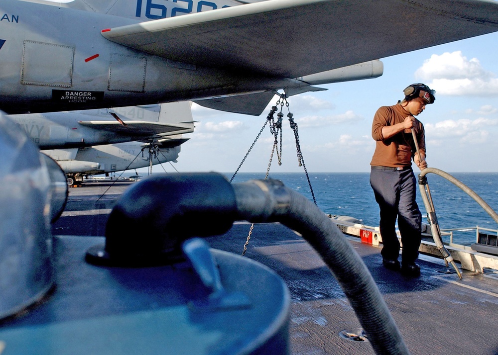Airman Tuia J. Mikaele cleans the deck
