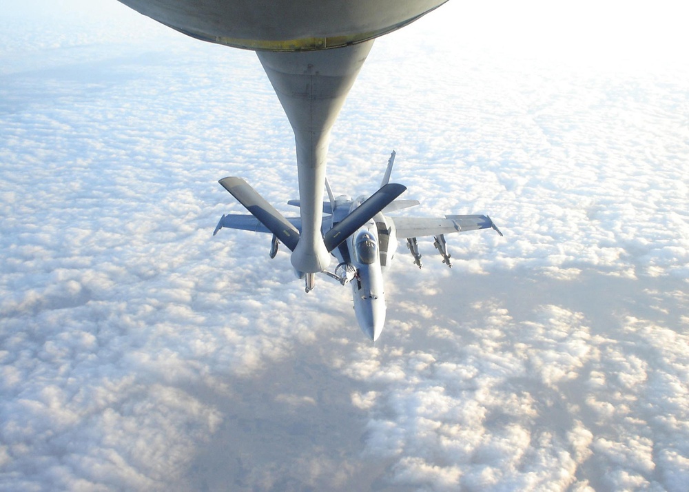 An F/A-18C Hornet refuels with a Air Force Tanker