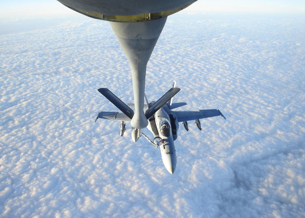 An F/A-18C Hornet refuels with a Air Force Tanker