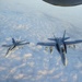 Two F/A-18C Hornet fly in formation after being refueled