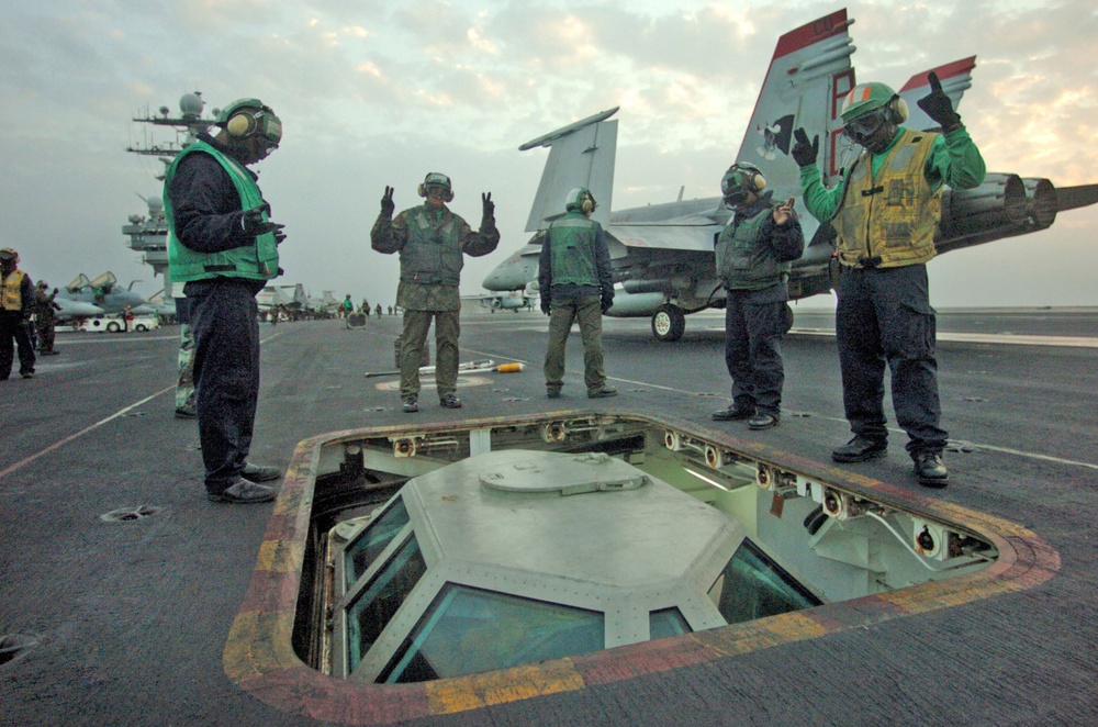 Sailors raise the Shooter Bubble on the flight deck