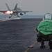 3rd Class Craig Spiering photographs an F/A-18C Hornet