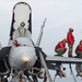 Sailors perform routine maintenance to an F/A-18 Hornet