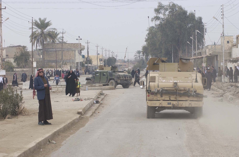 A U.S. Army convoy rolls through the city of Balad