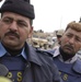 Two Iraqi policeman stand guard outside a polling center