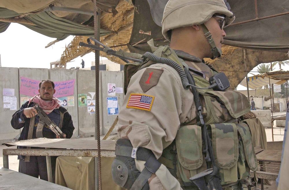 Capt. Delacruz speaks with Iraqi policeman about security