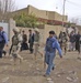 Soldiers walk with Iraqi Policeman to a house